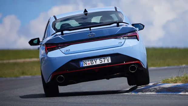 2021 Hyundai i30 Sedan N blue sedan exterior rear 3/4 action shot Wakefield Park 2