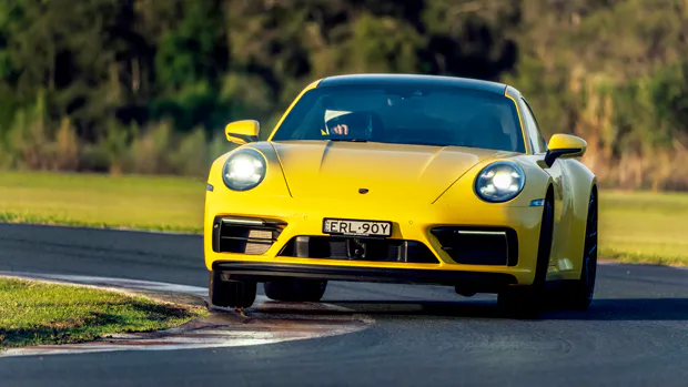 2022-Porsche-911-GTS-coupe-yellow---dynamic-front-3-4-shot-on-track,-sliding