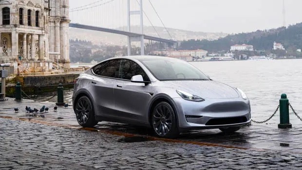 2023 Tesla Model Y with water and bridge in background