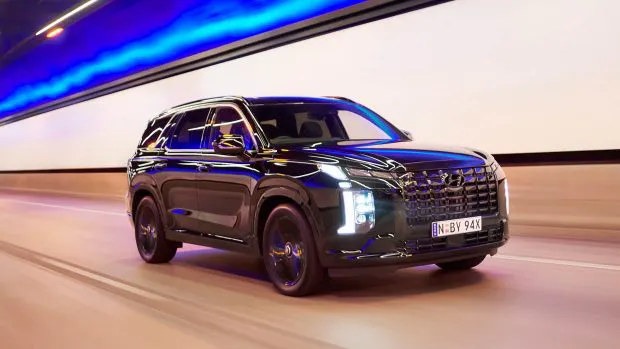 2024 Hyundai Palisade Calligraphy Black Ink driving on highway tunnel