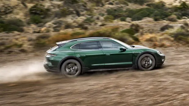 2024 Porsche Taycan Turbo Cross Turismo side angle driving on dirt shot