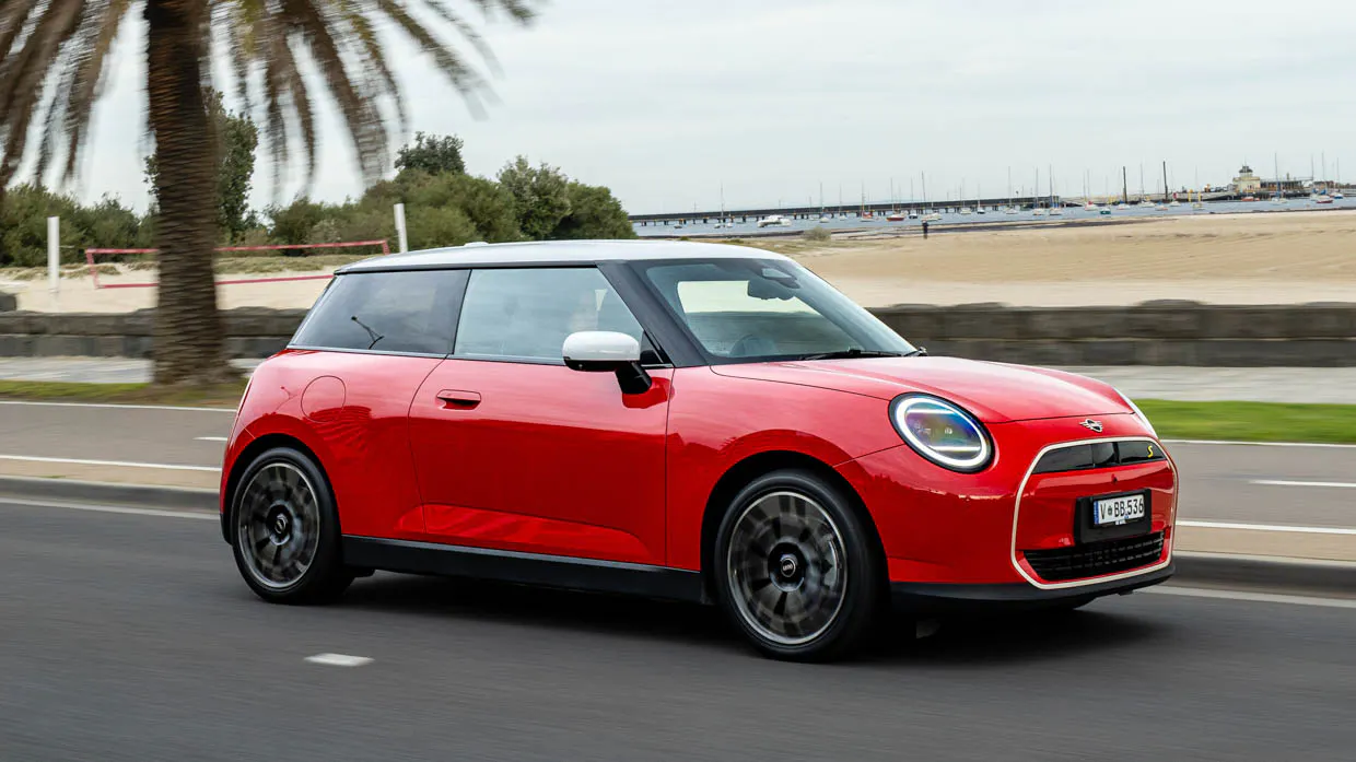 2024 Mini Cooper SE front 3/4 driving shot by the water