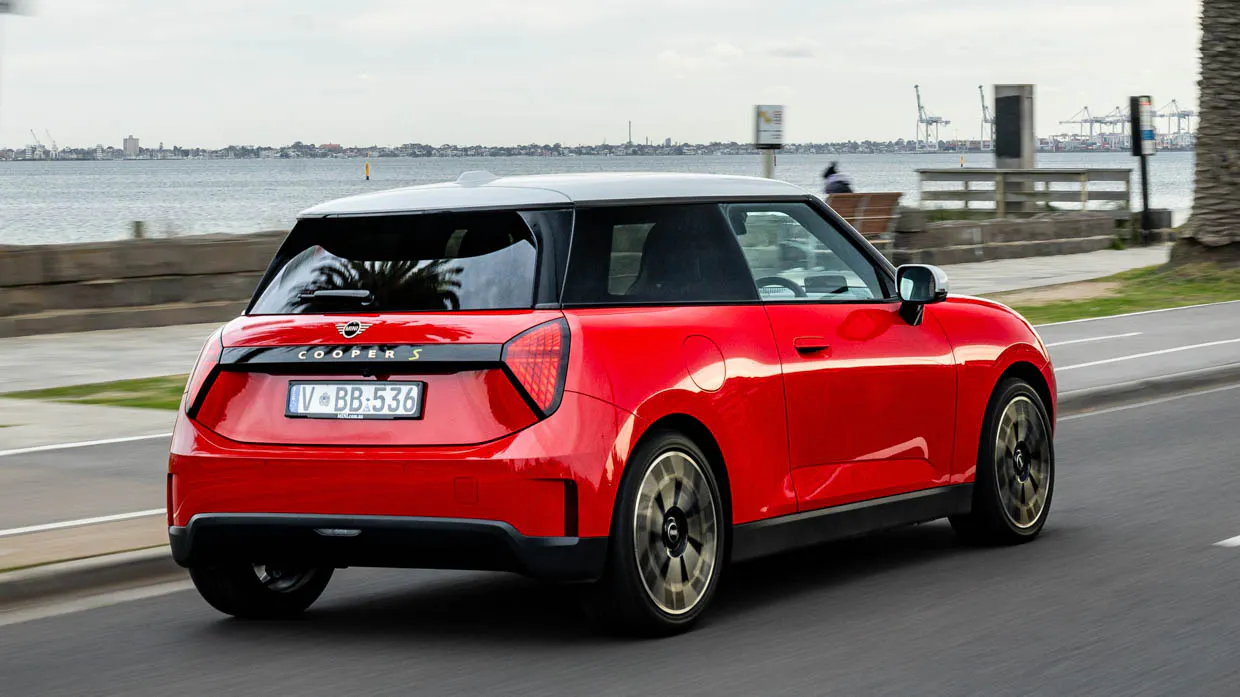 2024 Mini Cooper SE rear 3/4 driving shot by the water