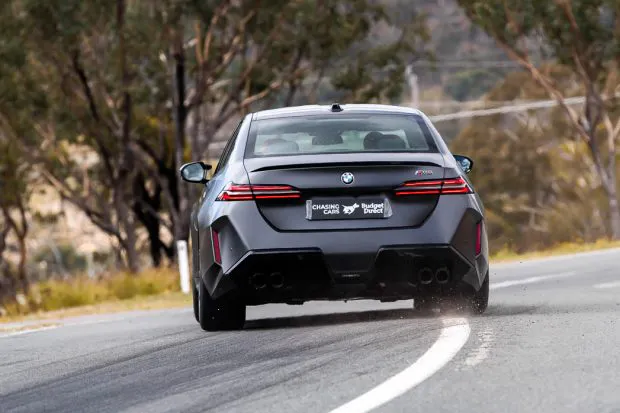 BMW M5 sedan 2025 driving rear